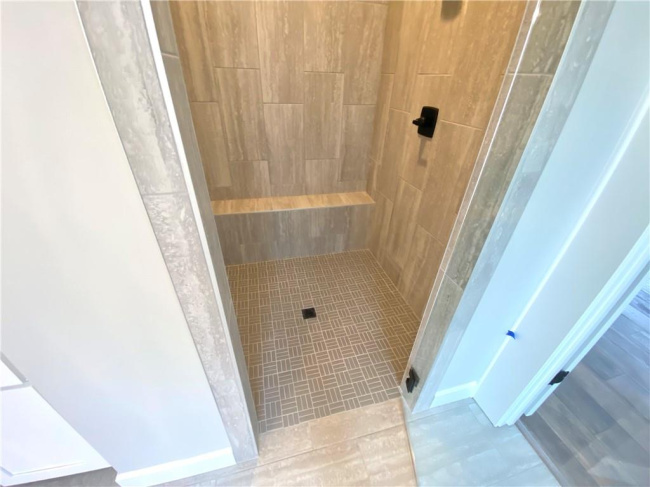 Bathroom featuring tile flooring and a tile shower